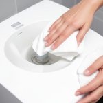 Person cleaning white water dispenser